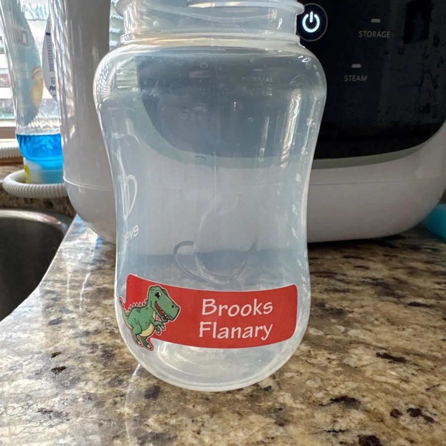 Dinosaur name label on a bottle